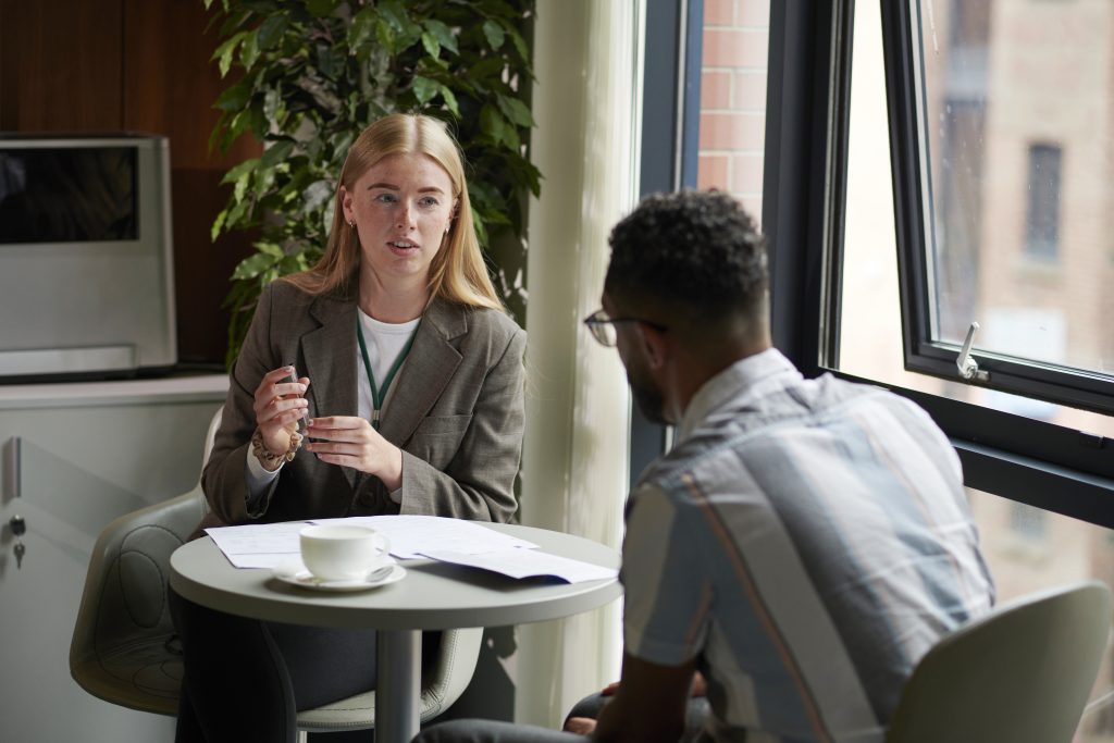 woman at table sitting across from man