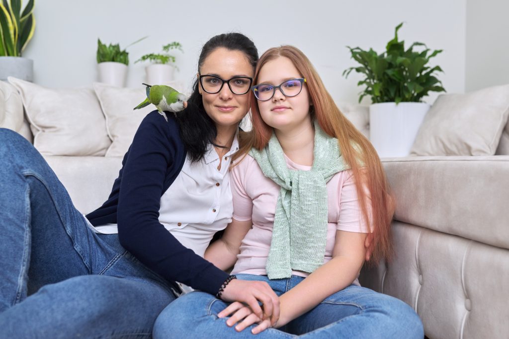 Two people sitting near a couch